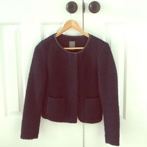 Wool boucle jacket with black piping at collar.
